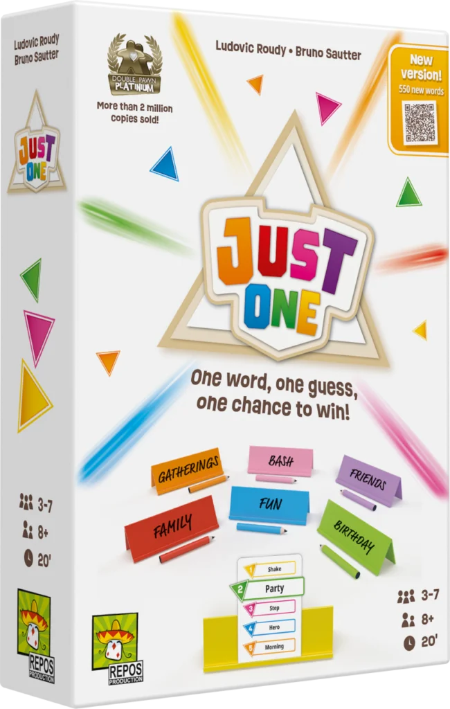 Caja blanca de Just One con caballetes, lápices y un sello de Spiel des Jahres
